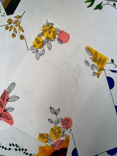 four pieces of paper with flowers painted on them