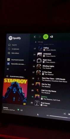 an image of the spotify website displayed on a computer screen in a dark room