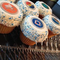 cupcakes with frosting and blue sprinkles on a cooling rack