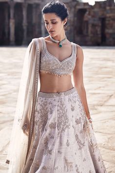 Introducing the tuscan beige lehenga, a masterpiece crafted from luxurious raw silk, exuding timeless elegance and sophistication. This exquisite ensemble showcases impeccable anmol dori work, meticulously depicting the breathtaking landscape of masai mara in an artful manner. Handwork highlighted with pearls, mirrors, and sequins adds a touch of opulence and charm to the intricate embroidery. Complemented by the iconic matsya v-wing belt, the tuscan beige lehenga captures the essence of traditi Matsya Lehenga, Handwork Lehenga, Beige Lehenga, Latest Bridal Lehenga Designs, Tuscan Landscape, Dori Work, Bridal Lehenga Designs, Latest Bridal Lehenga, Fancy Sarees Party Wear