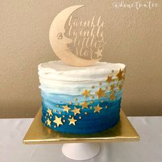 a blue and white cake with gold stars on it