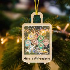 an ornament hanging from a christmas tree that says,'alei's adventures