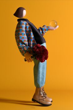 a doll holding a glass ball in its hand and wearing a colorful outfit with flowers on it