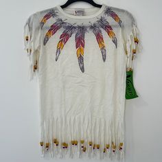 a white t - shirt with colorful feathers on the chest and fringes around it