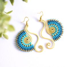 Elevate your style with our stunning swan-shaped handmade earrings, meticulously crafted with vibrant blue hues and intricate macrame details. These statement earrings are the epitome of funky jewelry, adding a whimsical touch to any outfit. Each earring features brass accents for an extra touch of elegance and sophistication. Whether you're treating yourself or searching for the perfect gift for her, these earrings are sure to delight. Shop now and make a bold statement with Zambilla & Co's uni Blue Macrame Dangle Earrings, Blue Dangle Earrings With Macrame, Intricate Macrame, Funky Jewellery, Earrings Macrame, Macrame Earrings, Statement Jewellery, Funky Jewelry, Jewellery Gift