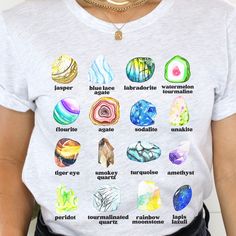 a woman wearing a t - shirt with different types of stones on it