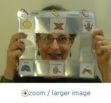 a woman holding up a large package with pictures on it's face and hands