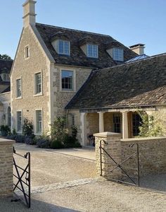 a stone house with a gate in front of it