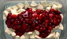 cherries and bananas are arranged in a heart shaped dish