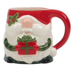 a ceramic mug with a santa clause holding a present