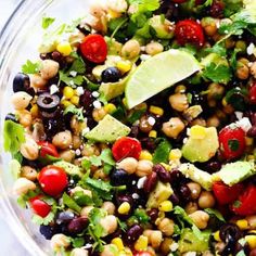 a salad with black beans, corn, avocado, tomatoes and cilantro