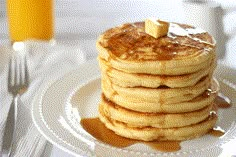 stack of pancakes with syrup and butter on white plate