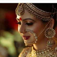 a woman with makeup and jewelry on her face