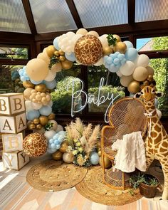 a baby shower with giraffe balloons and decorations