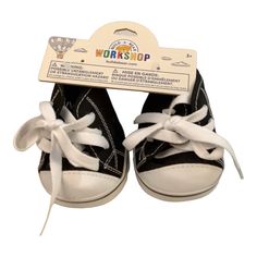 a pair of black and white baby shoes