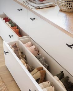 an open drawer with several pairs of shoes in it