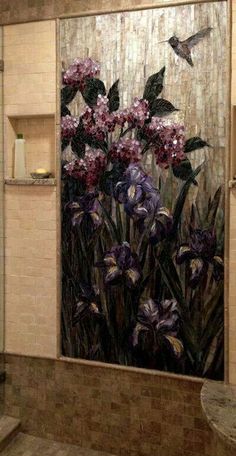 a bathroom with a painting on the wall and flowers in the bathtub next to it