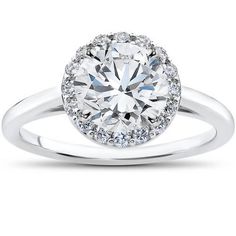 a white gold engagement ring with an oval center surrounded by round brilliant diamond halos