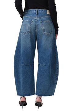 A superhigh waist and structured, curved wide legs cut a chic silhouette in these oversized, raw-cropped jeans crafted from nonstretch denim. 26 1/2" inseam; 20" leg opening; 13 1/4" front rise Button fly Five-pocket style 100% regenerative cotton Machine wash, tumble dry Made in the USA Modern Wide Leg Cropped Jeans, Oversized Jeans, Latest Jeans, Citizens Of Humanity Jeans, Jean Crafts, Raw Hem Jeans, Citizens Of Humanity, Free Fabric, Cropped Jeans