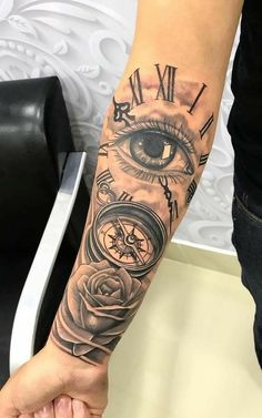 a person with a clock and rose tattoo on their arm