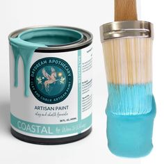 a paint can and brush sitting next to each other