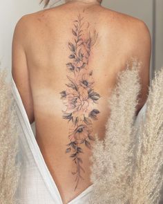 the back of a woman's body with flowers on it