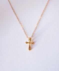 "A gorgeous tiny and simple, Gold Vermeil cross hangs delicately from a 14k Gold Filled chain. This little cross has softly rounded edges and is super smooth. A beautiful keepsake piece of jewelry or baptism, dedication gift that will last a lifetime. - Pendant - Gold Vermeil - 13mm x 9mm (Made in the USA) - Chain + components - 14K Gold-Fill - Clasp - 14K Gold-filled lobster clasp . . . . . . . . . . . . . . . . . . . . . . . . . . . . . . . . . Want more for bridesmaids, sisters or friends? I Gold Minimalist Tarnish Resistant Cross Necklace, Minimalist Crucifix Jewelry With Delicate Chain, Minimalist Crucifix Charm Necklace As Gift, Gold Crucifix Charm Necklace In Minimalist Style, Gold Minimalist Crucifix Charm Necklace, Simple Cross Jewelry With Delicate Chain, Minimalist Gold Crucifix Charm Necklace, Dainty 14k Gold Cross Necklace With Delicate Chain, Dainty 14k Gold Cross Necklace