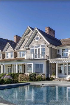 a large house with a pool in front of it