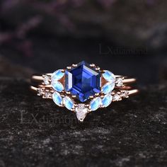 an engagement ring with blue topazte and white topaztes on the side