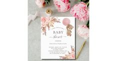 a baby shower with pink flowers and balloons