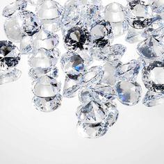 many diamonds are scattered on a white surface