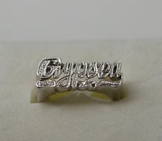 Cursive style name ring in silver decorated with hand beading is a perfect statement ring for you. Use this modern name ring also as a knuckle ring (go one size smaller than your regular finger size) or as a Pinky ring. You could also do other word phrases with single ring or a double 1. Team name. 2. Group name. 3. Sports team name. 4. MEN NAME and many more....( contact me for more info) 5. A.K.A names. All my beautiful name rings and other pieces are proudly made in USA! **COLOR** gold rhodiu Silver Promise Jewelry With Names, Elegant Silver Rings With Names, Silver Promise Ring With Name, Personalized Symbolic Silver Jewelry, Symbolic Silver Jewelry With Name Detail, Silver Open Ring With Name Detail, Symbolic Silver Jewelry With Name, Custom Name Silver Rings, Silver Engraved Open Ring With Name