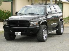 a black suv parked in front of a building