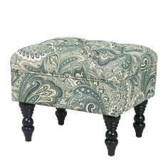 the foot stool is made from wood and has an ornate pattern on it's legs