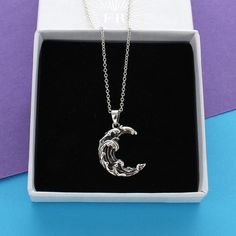 A stunning sterling silver necklace featuring a moon shaped charm detailed with waves in the centre of a delicate trace chain. The sterling silver charm sits centrally on beautifully delicate sterling silver trace chain. The necklace is finished with a simple spring clasp making it very easy to put on. Each piece arrives in a beautiful White gift box with a contrasting silver logo. A free gift wrapping service is also available upon request. Made from Sterling silver Dimensions Charm height 2cm Silver Logo, Un Logo, Moon Shapes, Logo A, Moon Charm, Gift Wrapping Services, White Gift Boxes, Free Gift Wrapping, Sterling Silver Charm