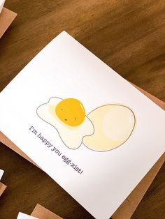 an egg is sitting on top of a card that says, i'm happy birthday