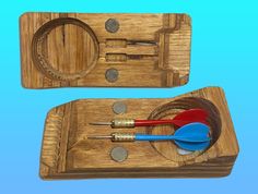 two wooden trays with scissors and other items in them on top of each other