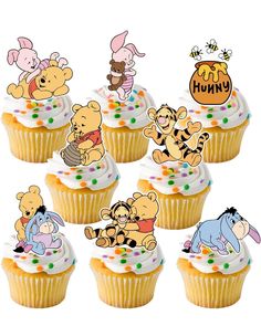 winnie the pooh cupcakes with frosting and decorations are arranged on top of each other