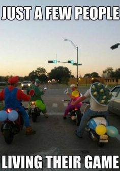 some people on motor bikes with balloons in the back and one person riding a scooter