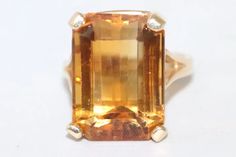 Stunning 14K Yellow gold ring showcasing a beautiful 14.0 CT faceted prong set emerald cut citrine. This ring is a size 6.5 and has a total weight of 9.5 grams. This ring is hallmarked 14K yellow gold and has been checked by a professional for authenticity. Citrine Ring, Staten Island, Yellow Gold Ring, Yellow Gold Rings, Emerald Cut, Prong Setting, Gold Ring, Citrine, Statement Rings