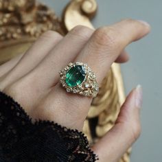 Read about our payment plans before proceeding. Our "Tulip Majesty Emerald Bloom Ring." A mesmerizing oval emerald, reminiscent of a lush oasis, is embraced by delicate tulip petals, accented by sparkling diamonds. Experience the essence of spring's romance captured in this timeless treasure. Perfect for those who seek nature's elegance and enduring beauty. Crafted by skilled hands, this ring is available in your choice of 14K and 18K yellow gold, rose gold, and white gold. All emeralds are natural so it can differ from the image. All orders come in our Tippy Taste ring box. This ring is handmade and designed in NYC. 14K or 18K solid gold Natural 10*8mm oval emerald. Approx. 2.5ct Natural diamonds. SI clarity, GH color, 0.08ct total carat weight ** Tippy Taste Heirloom Collection is made t Luxury Oval Emerald Heirloom Ring, Luxury Antique Oval Emerald Ring, Luxury Oval Emerald Birthstone Ring, Exquisite Oval Green Emerald Ring, Exquisite Green Oval Emerald Ring, Exquisite Oval Emerald Ring In Yellow Gold, Elegant Marquise Emerald Ring, Exquisite Green Oval Ring, Oval Tsavorite Wedding Ring