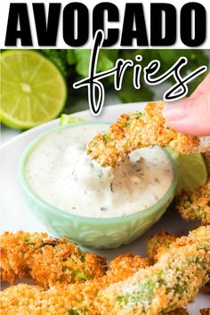 a hand dipping something into a small bowl filled with ranch dressing and fried chicken tenders