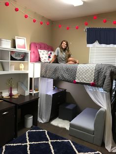 a woman sitting on top of a bunk bed