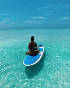 a person sitting on a surfboard in the ocean