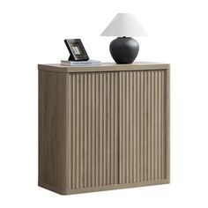 a wooden cabinet with a lamp on top and a cell phone sitting on it's side