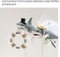 two wedding cake toppers with shark decorations on them