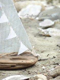 a small sailboat sitting on top of a sandy beach