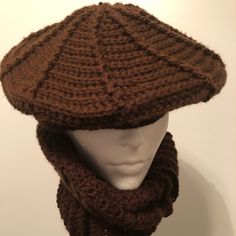 a knitted hat and scarf on top of a mannequin's head