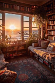 a living room filled with furniture and a large window covered in bookshelves overlooking the ocean