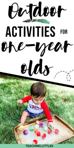 a toddler playing with an outdoor one - year old's game in the grass